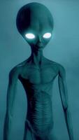 3D rendering. Scary gray aliens walk and look blinking on a dark smoky background. futuristic concept. video