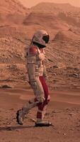 3d rendering. Astronaut in white space suit walking on Mars red desert landscape. Space exploration mission concept, rocky terrain and mountains under orange sky atmosphere. video