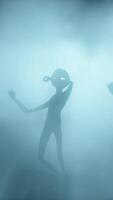 3D rendering. Scary gray aliens dancing on a dark background. UFO futuristic concept. video