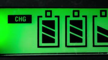 Macro Close-up of Battery Charging Indicator Display with Green Backlight in Electronic Device video