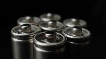 Close-up of Rotating Metallic Batteries Clustered Together on Dark Background for Energy Concepts video