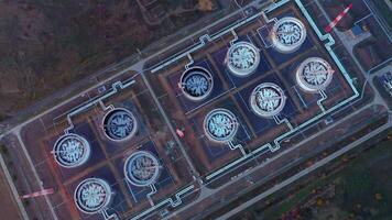 Aerial top view of rows of oil tanks connected by pipes at a refinery. video