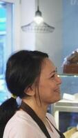 Charming interaction between a young man and a female baker in a cozy bakery video