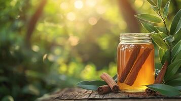 Cinnamon and honey in a jar on a wooden table photo