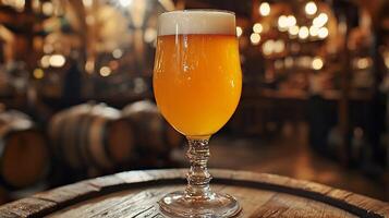 A glass of beer sitting on top of a barrel photo