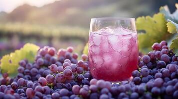A glass of grape juice sitting on a bunch of grapes photo