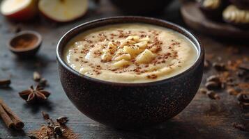 A bowl of smoothie with cinnamon and apples photo