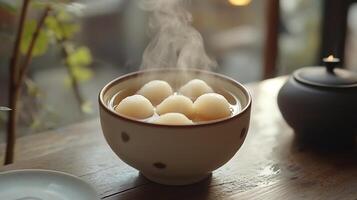 A cup of steaming hot water with some balls in it photo