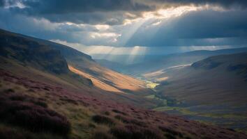 Sun Rays Over Valley Creating Dramatic Light and Shadow on Landscape photo