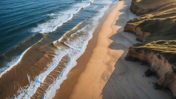 Aerial View of Waves Crashing on Sandy Beach with Coastal Cliffs photo