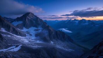 Majestic Mountain Range Landscape at Dusk with Cloud Covered Peak photo