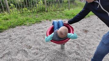 Child Enjoying Spinning Ride in Park Playground video