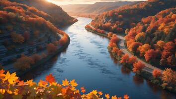 Scenic River Valley with Autumn Foliage and Winding Road at Sunset photo
