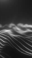 Monochrome abstract wave of luminous dots creating a flowing digital mesh landscape in black and white video