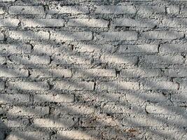 Cement Brick Wall with Pattern of Shadow lines on Wall. Background Cocnept photo