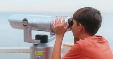 Child Using Binoculars at Scenic Overlook by the Sea video