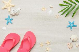 Pink flip flops, seashells, and starfishes creating relaxing summer beach background photo