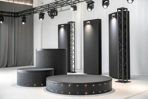 Modern black stage setup with lighting and backdrops photo