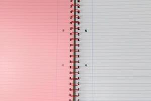 Spiral bound lined notebook with light pink page photo