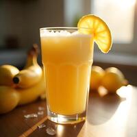Serving of Yellow Fruit Juice with Lemon Slice and Bananas photo