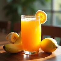 Banana Orange Juice with Lemon Slice and Fresh Fruit on Table photo