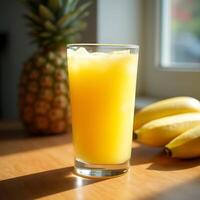 Refreshing Pineapple Juice in Glass with Bananas and Pineapple photo