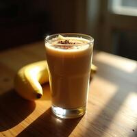 Enjoying Banana Smoothie with Chocolate Topping on Wooden Table photo