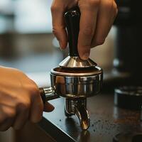 Tamping Coffee Grounds in a Portafilter for Espresso Preparation photo