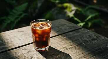 Cold Brew Coffee with Ice on a Wooden Table Outdoors photo