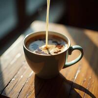 Pouring Cream Into Coffee Cup on Wood Table in Morning Light photo