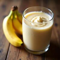 Enjoying a Delicious Banana Smoothie in Glass on Wood Table photo
