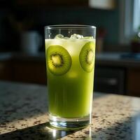 Making Green Juice Drink with Kiwi Slices and Ice Cubes photo