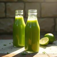 Green Juice in Glass Bottles with Limes on Sunny Patio photo