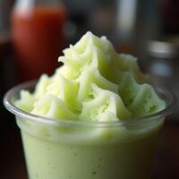 Refreshing Green Smoothie in Plastic Cup with Frosted Top photo