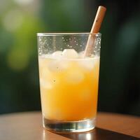 Refreshing Orange Drink with Ice and Wooden Straw Close Up photo