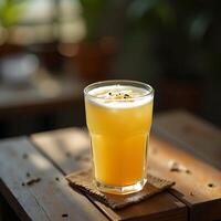 Drinking Refreshing Yellow Beverage on Wooden Table with Seeds photo