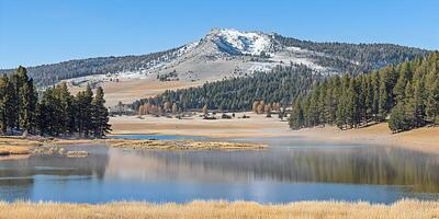 Scenic Mountain Lake in Autumn with Snow-capped Peak photo