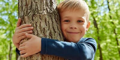 Happy Boy Hugging Tree Trunk in Sunny Forest Nature Childrens Day photo