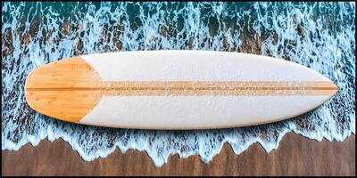 Top View Bamboo Surfboard on Sandy Beach with Waves photo