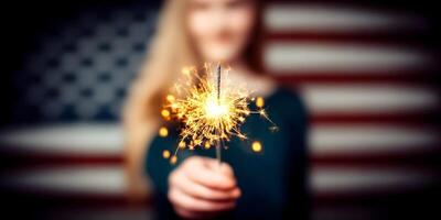 Girl Holding Burning Sparklers Fireworks Against Blurred American Flag Background photo