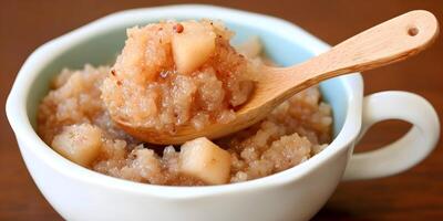 Sweet Rice Porridge with Pears in White Bowl Wooden Spoon photo