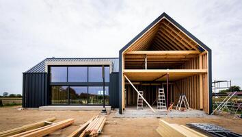 Modern Barnhouse Under Construction on a Cloudy Day photo