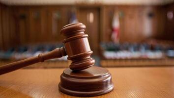 Photorealistic close up of a gavel hitting in a courtroom photo