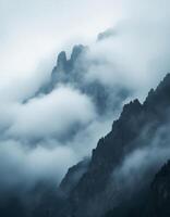 Misty Mountain Peaks, Jagged rocks emerge from dense fog creating an ethereal atmosphere photo