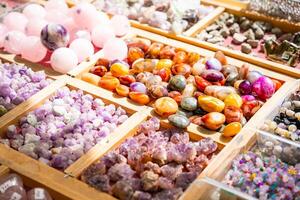 Stall filled with various precious and semi precious stones and crystals Altai Russia. Colorful collection of natural minerals for sale and display. High quality photo