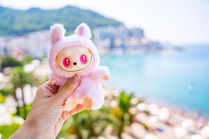 Budva, Montenegro - June 12, 2025. LaBubu toy from Pop Mart held in hand against blurred outdoor background. Minimalist focus on popular collectible figure in real-life setting. High quality photo