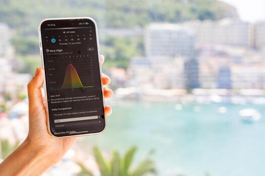 Budva, Montenegro - June 12, 2025. Close-up of iPhone screen displaying UV index in weather app. Real-time ultraviolet radiation level shown on smartphone interface. photo