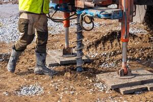 Close-up of soil sampling during pile drilling process. Extraction of subsurface material for geotechnical analysis and foundation assessment. High quality photo