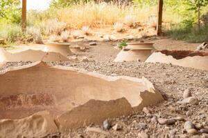 Clay wine vessels embedded in earth beneath wooden shelter at Armaziskhevi site, part of an ancient wine making cellar in Mtskheta region, Georgia. photo