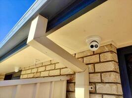 A camera mounted on the side of a house photo